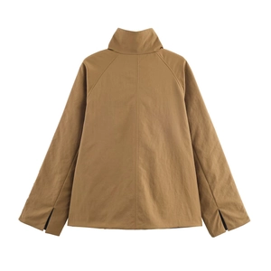 Detail view of the back of a brown reversible windbreaker jacket with raglan sleeves