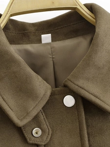 Detail of brown faux suede bomber jacket showing collar and silver metal button
