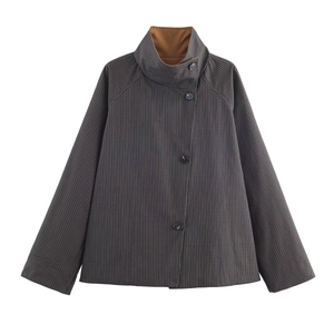 Detail view of dark grey pinstripe jacket featuring funnel neck and brown lining contrast