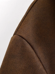 Detailed view of the fine stitching and soft suede texture on a vintage brown jacket