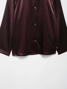 Detail showing the glossy silk satin fabric and matching buttons of this purple shirt jacket
