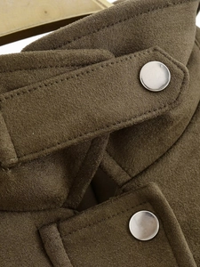 Close-up of military green suede bomber jacket with silver metal snap buttons