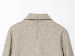 Details vom Kragen der haferfarbenen Wolljacke und präzise Rückennaht-Verarbeitung