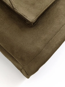 Detailed macro view of premium brown faux suede texture with precise stitching craftsmanship