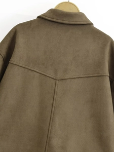 Macro shot of dark brown suede bomber jacket showing back yoke stitching detail