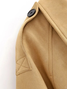 Macro detail of camel suede coat featuring epaulets with buttons and refined stitching