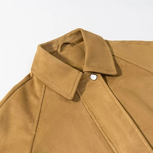 Close-up of camel faux suede bomber jacket featuring lapel collar and metal snap button