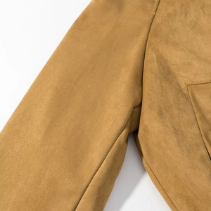Close-up of fine stitching and suede texture on a camel bomber jacket shoulder
