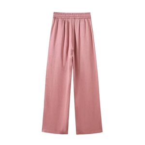 Detailed macro view of high-waist wide-leg pants with vertical pleated fabric and elastic waistband