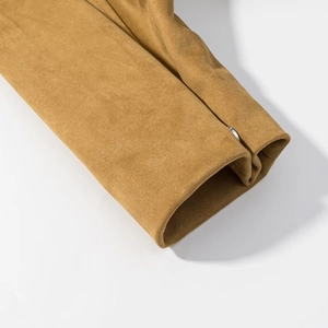 Detail of suede pilot jacket sleeve showing soft ginger fabric and silver metal button