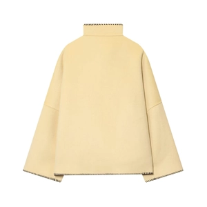 Detail of cream wool jacket back showing black whipstitch seams and high stand collar