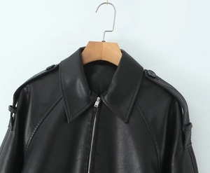 Detailed view of black PU leather jacket featuring classic lapels and silver metal zipper