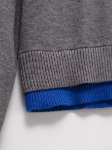 Detail of the knit cardigan with grey fabric and blue ribbed hem in faux two-piece design