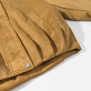 Detail of camel suede bomber jacket with silver snap button and pocket tailoring