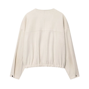 Détail des coutures arrière et de l'ourlet élastique d'une veste beige en daim synthétique