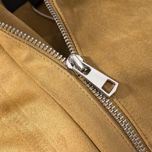 Detailed close-up of premium mustard yellow suede texture and silver metal zipper teeth