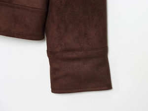 Macro shot showing high-quality stitching and faux suede texture on a brown jacket