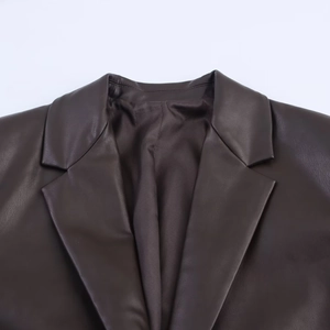 Detailed close-up of dark brown faux leather blazer featuring classic notched lapels