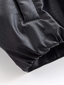 Macro detail of high-quality black faux leather jacket texture and precision stitching