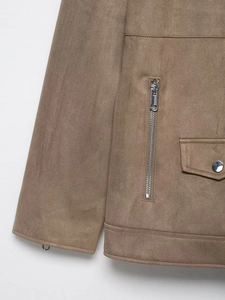 Detailed macro view of faux suede texture with metallic zippers and stitched seams