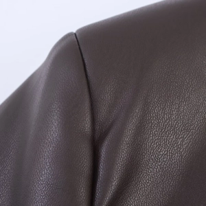 Close-up of double stitching and pebbled texture on dark brown PU leather blazer shoulder