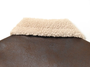 Close-up of the vintage brown leather collar with plush white faux shearling lining