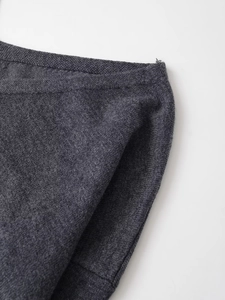 Detailed close-up showing the charcoal grey knit fabric texture and hem stitching