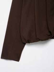 Detailed view of the dark brown pleated cuffs and hem on this stylish knit flight jacket