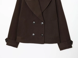 Detailed view of the dark brown double-breasted short wool coat with twill texture