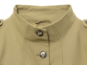 Detail of khaki jacket showing stand collar, buttoned epaulets and twill fabric texture