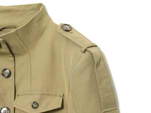 Close-up of khaki jacket featuring stand collar, shoulder epaulets and tortoiseshell buttons