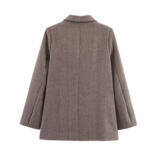Detail of herringbone pattern texture and back tailoring of a brown wool blazer