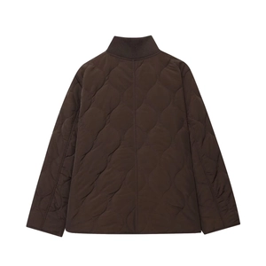 Macro view of dark brown onion-quilted texture and rib-knit collar on winter jacket