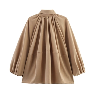 Detailed view of the pleated back design on a khaki lantern sleeve blouse for women
