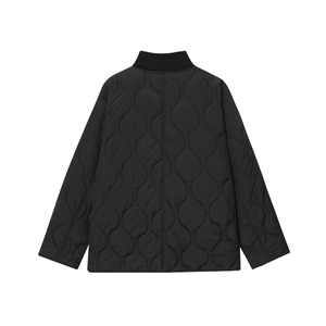 Macro detail of the black onion-quilted jacket featuring a ribbed stand collar and H-line cut