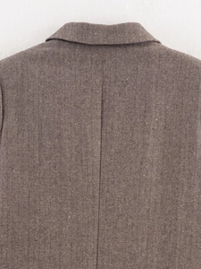 Detail shot of brown herringbone wool blend blazer showing premium stitching and fabric texture