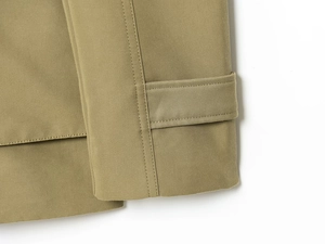Close-up of khaki jacket sleeve straps and high-density twill fabric stitching detail