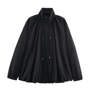 Detailed view of black bomber jacket with ruched stand collar and golden tipped drawstrings