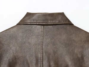 Detailed macro view of brown PU leather collar and stitching on autumn long jacket