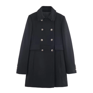 Detail of black wool coat featuring silver embossed crest buttons and flap pocket