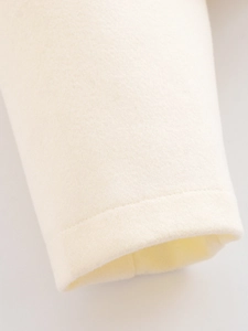 Close-up of cream wool bomber jacket sleeve with premium stitching and soft texture
