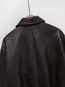 Close-up of the back shoulder and collar detail on a loose-fit faux leather jacket