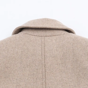 Macro detail of camel wool coat collar and back seam stitching with premium texture