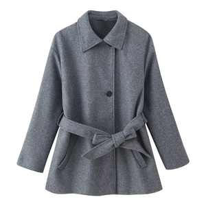 Detailed view of the double-layer lapel and tied waist belt on a grey wool blend coat