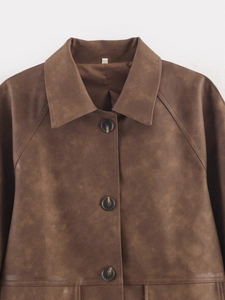 Detailed view of the dark brown PU leather jacket with classic lapel and resin buttons