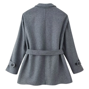 Detail of dark grey wool coat back with waist belt and decorative cuff straps