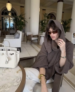 Detail of coffee-colored oversized hooded knit sweater with vertical texture and drop shoulders