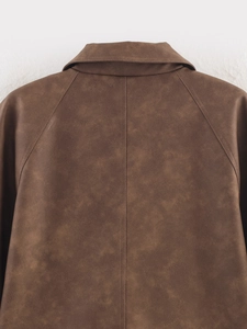 Close-up of the vintage brown faux leather jacket back with wide collar and raglan sleeve seams
