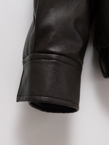 Detailed macro view of high-quality faux leather jacket cuff with fine grain and double stitching