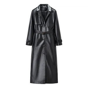 Detail of black faux leather trench coat showing lapel, buttons, and matching waist belt